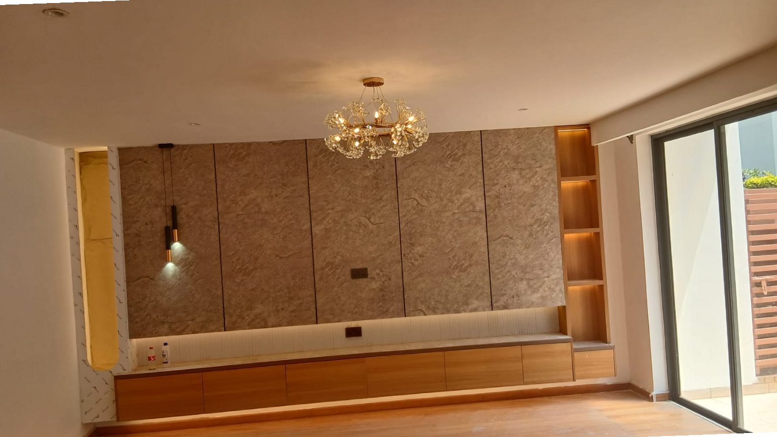 Dining area feature wall with textured panelling and pendant lighting