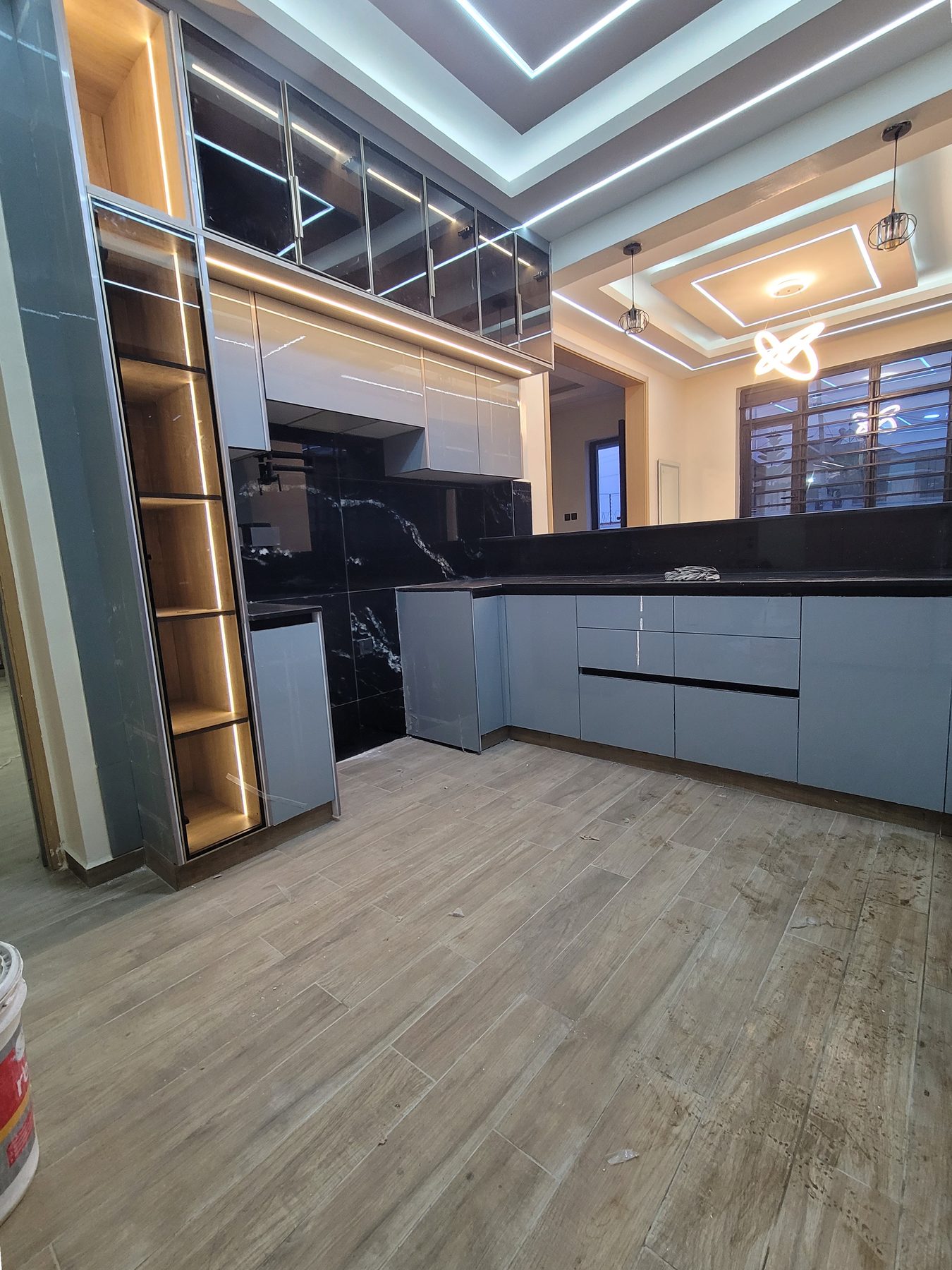 Kitchen cabinetry beneath a cove-lit gypsum ceiling