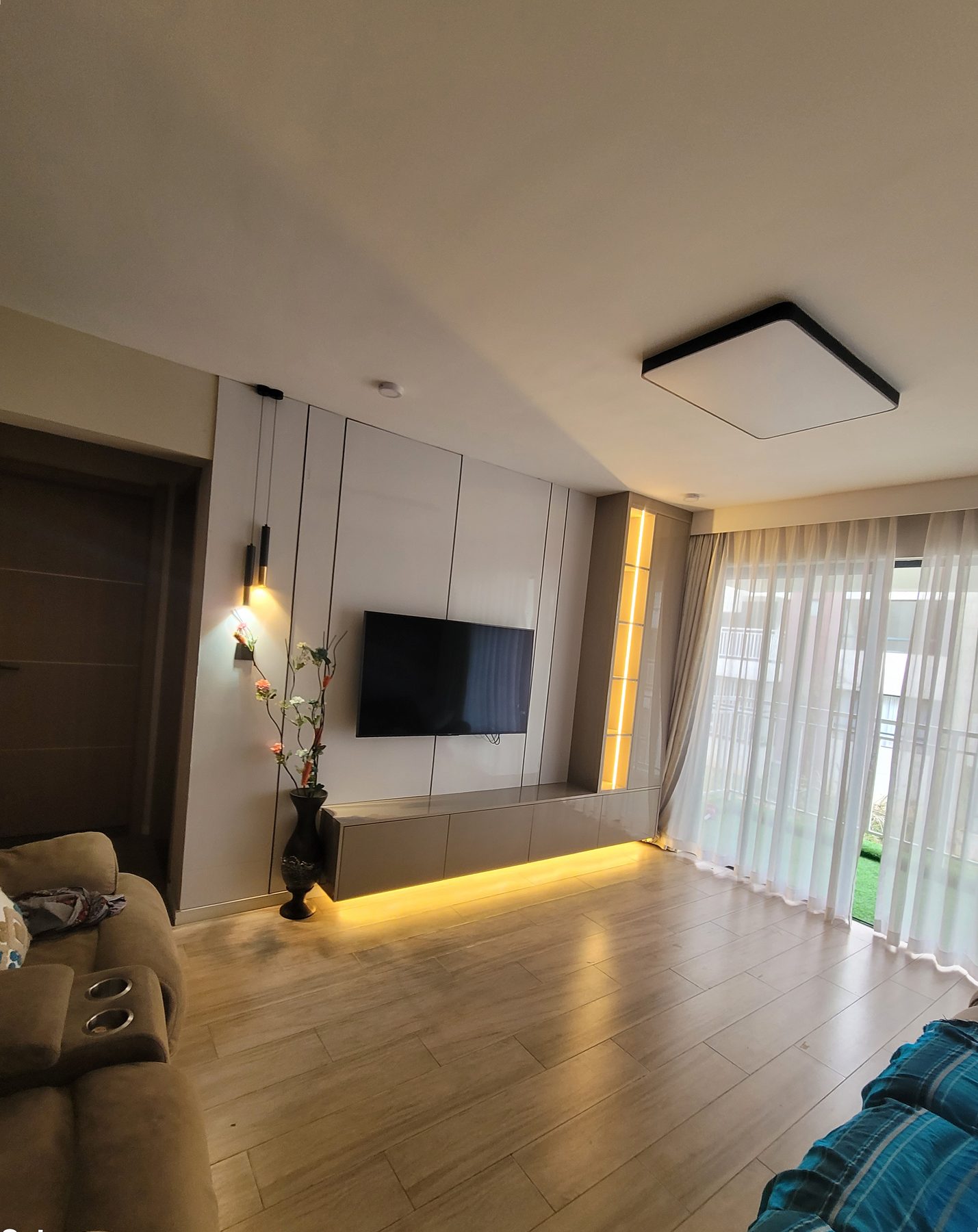 Living room feature wall with pendant lighting and a floating TV console