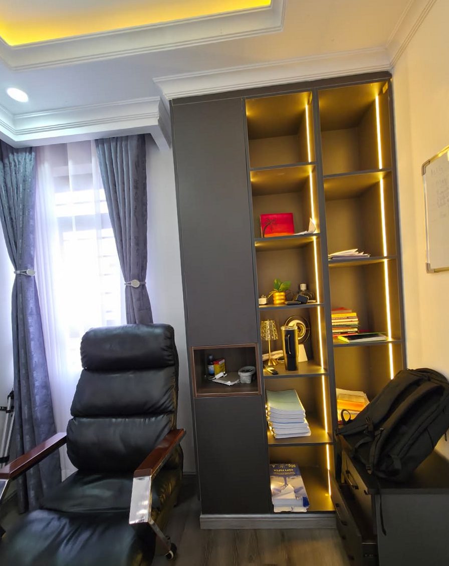 Built-in office wardrobe and shelving unit with warm LED-lit compartments