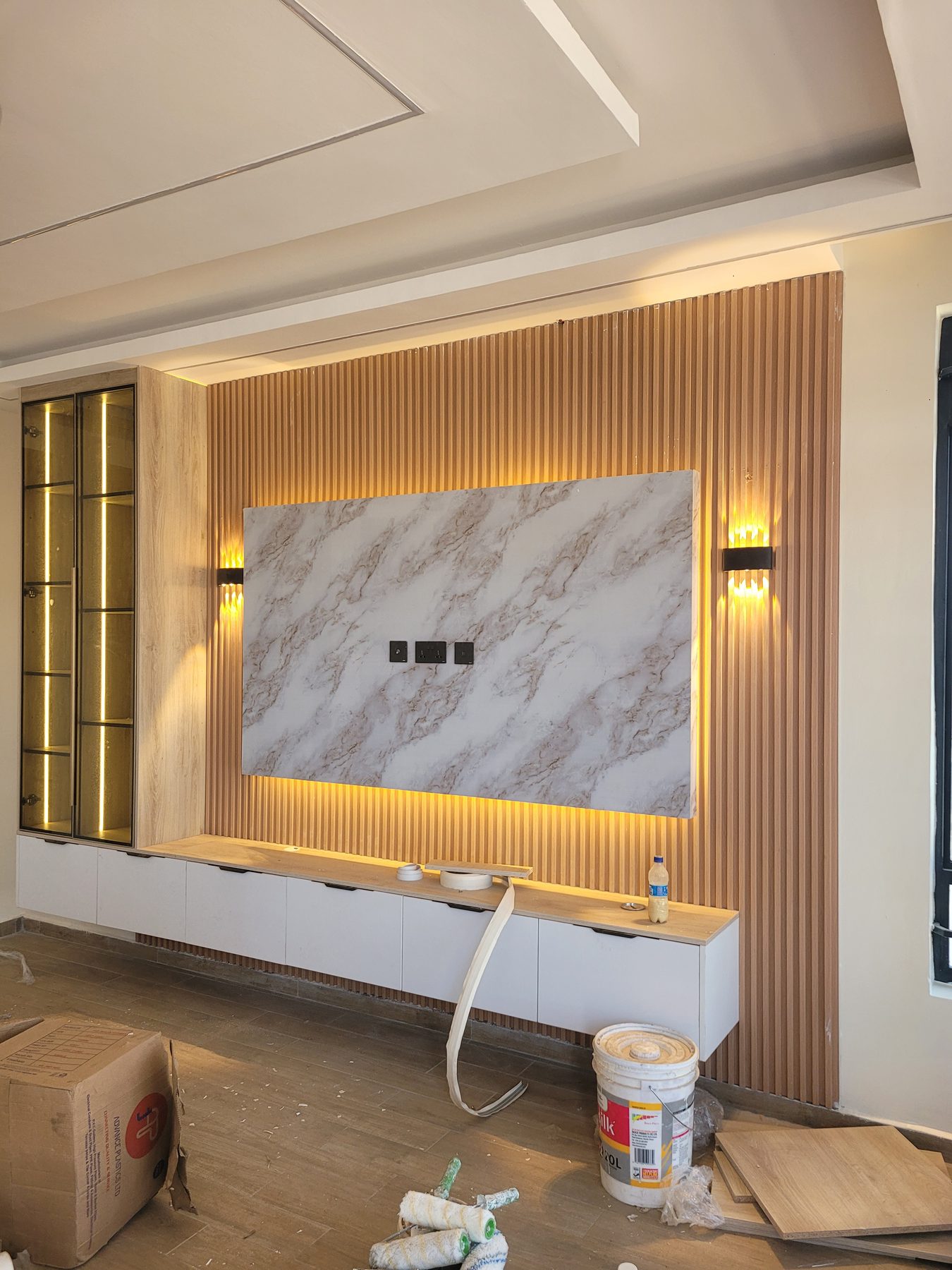 TV feature wall in fluted timber with a backlit marble panel